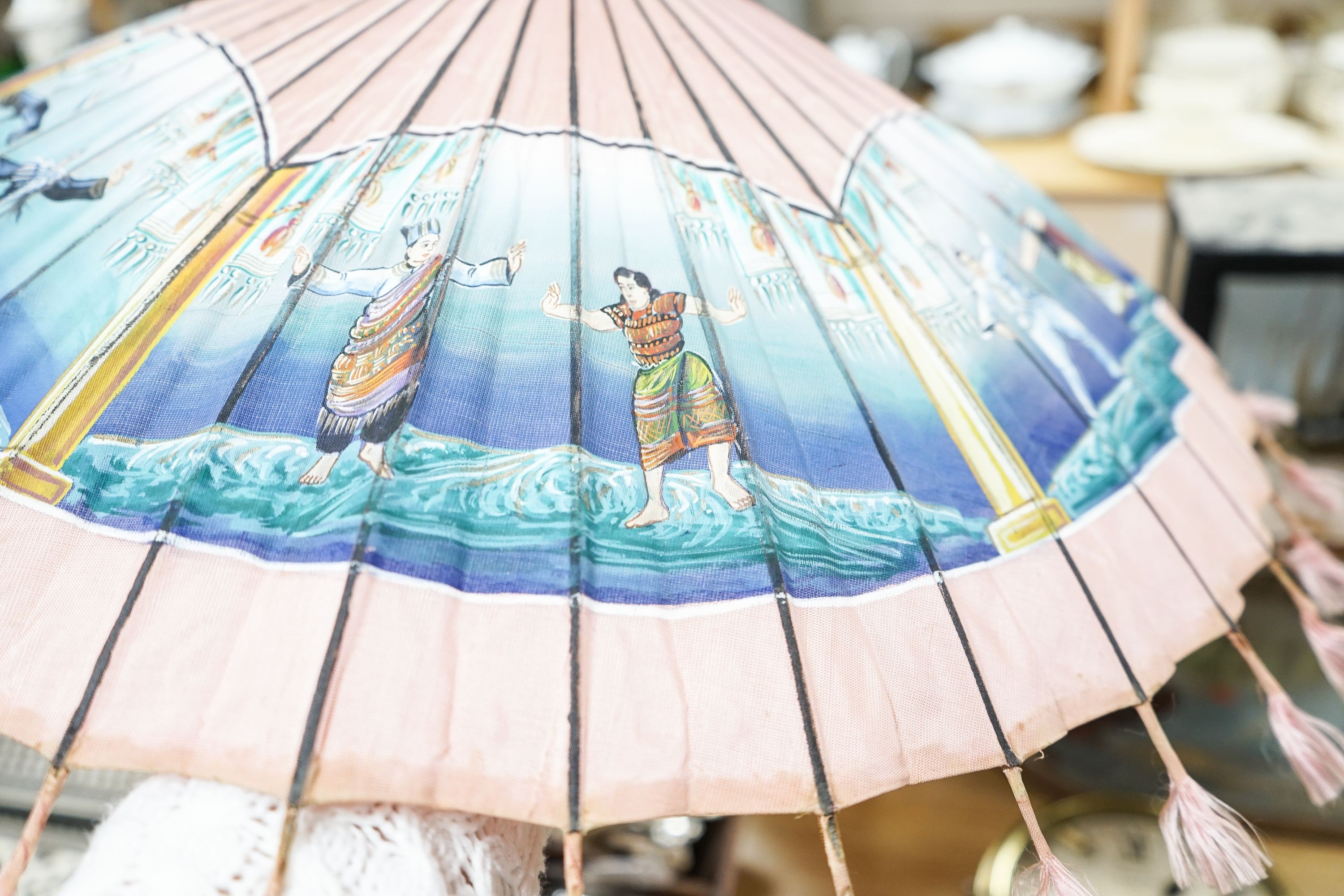 A 19th century Chinese Canton export ivory parasol with carved Ivory handle and a Burmese white metal handled painted fabric parasol